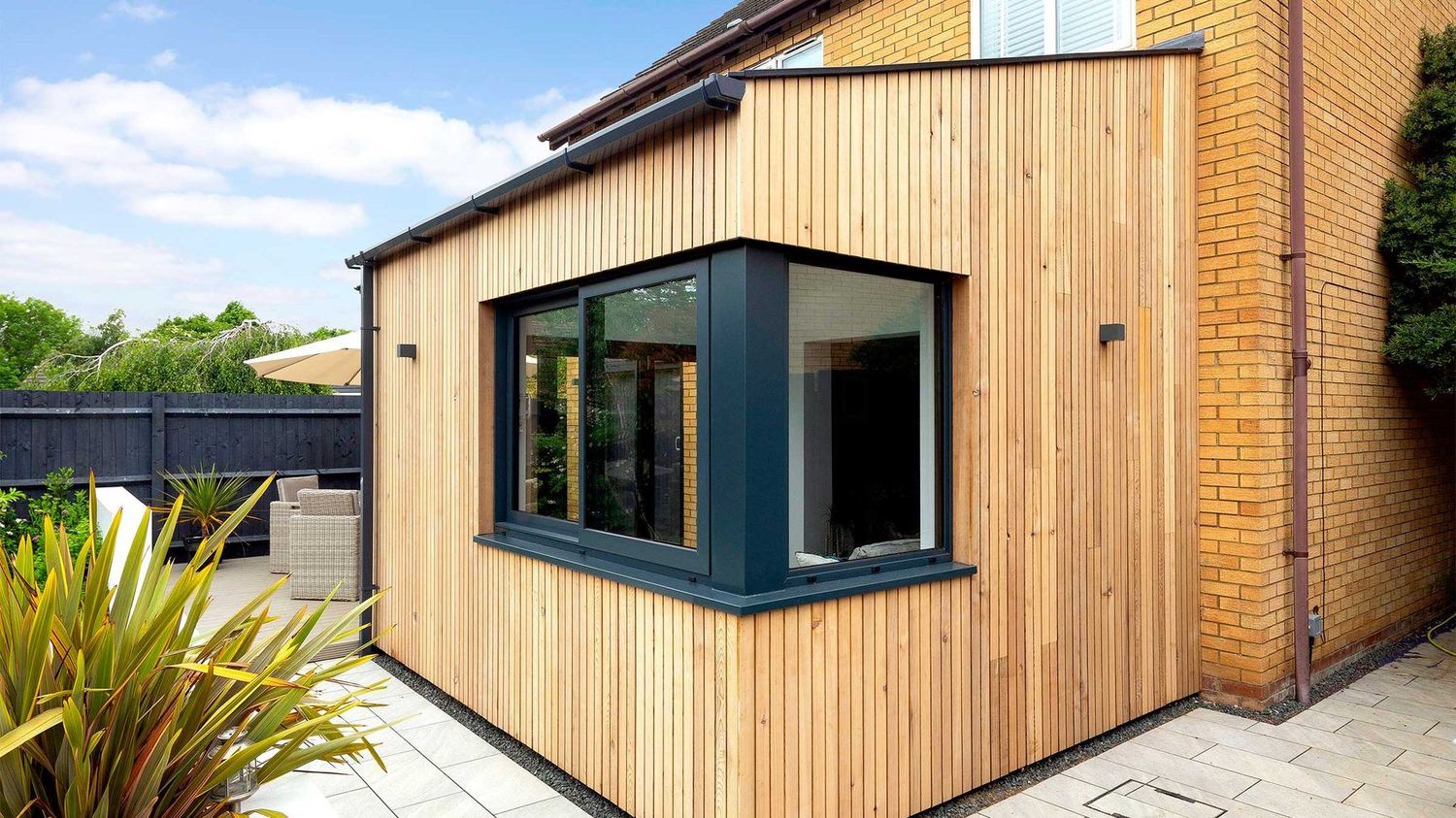 Cedar cladding and dark bay window