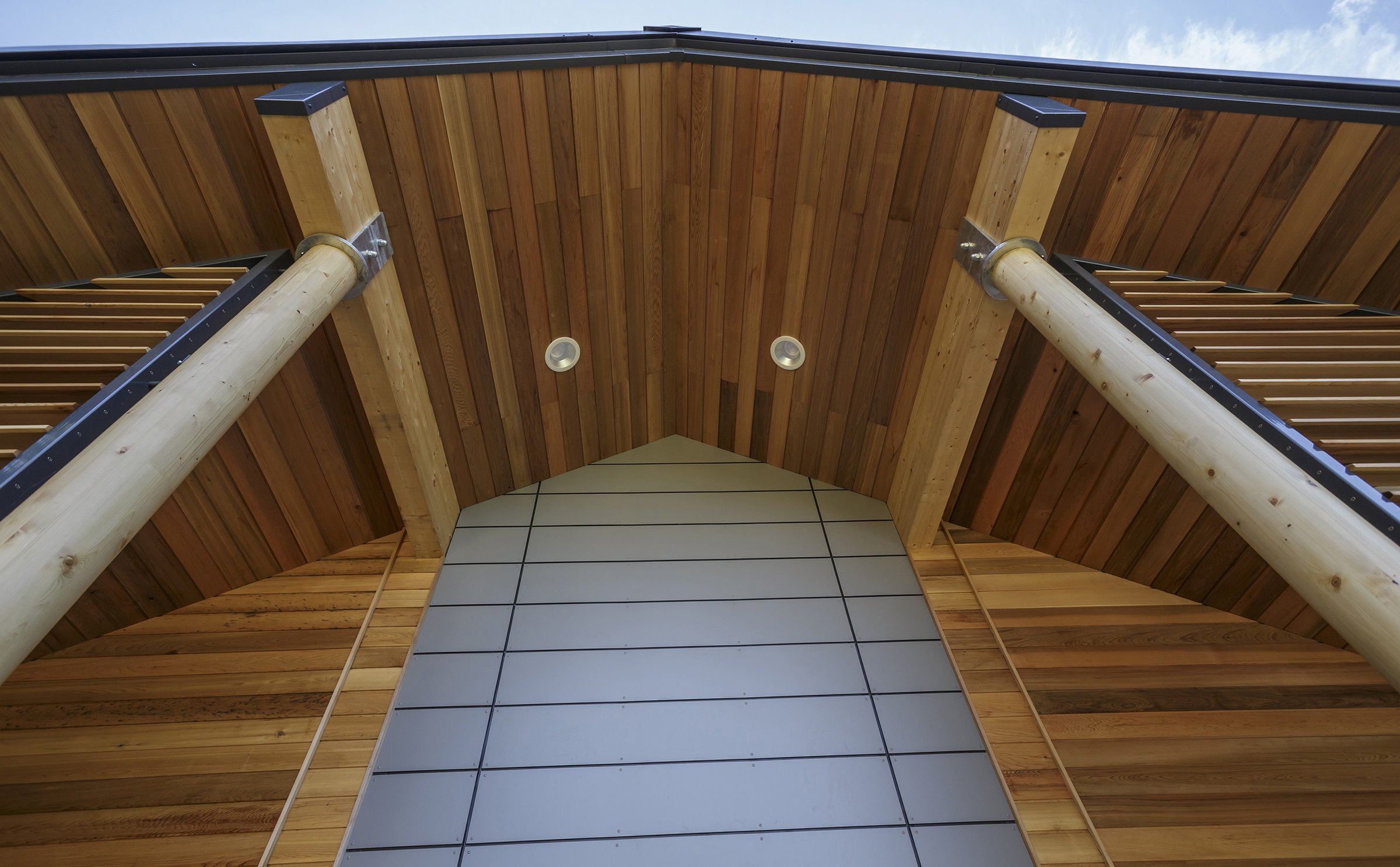 Looking up at the Lavenham nursery entrance: a cedar soffit and gable carried on round timber columns
