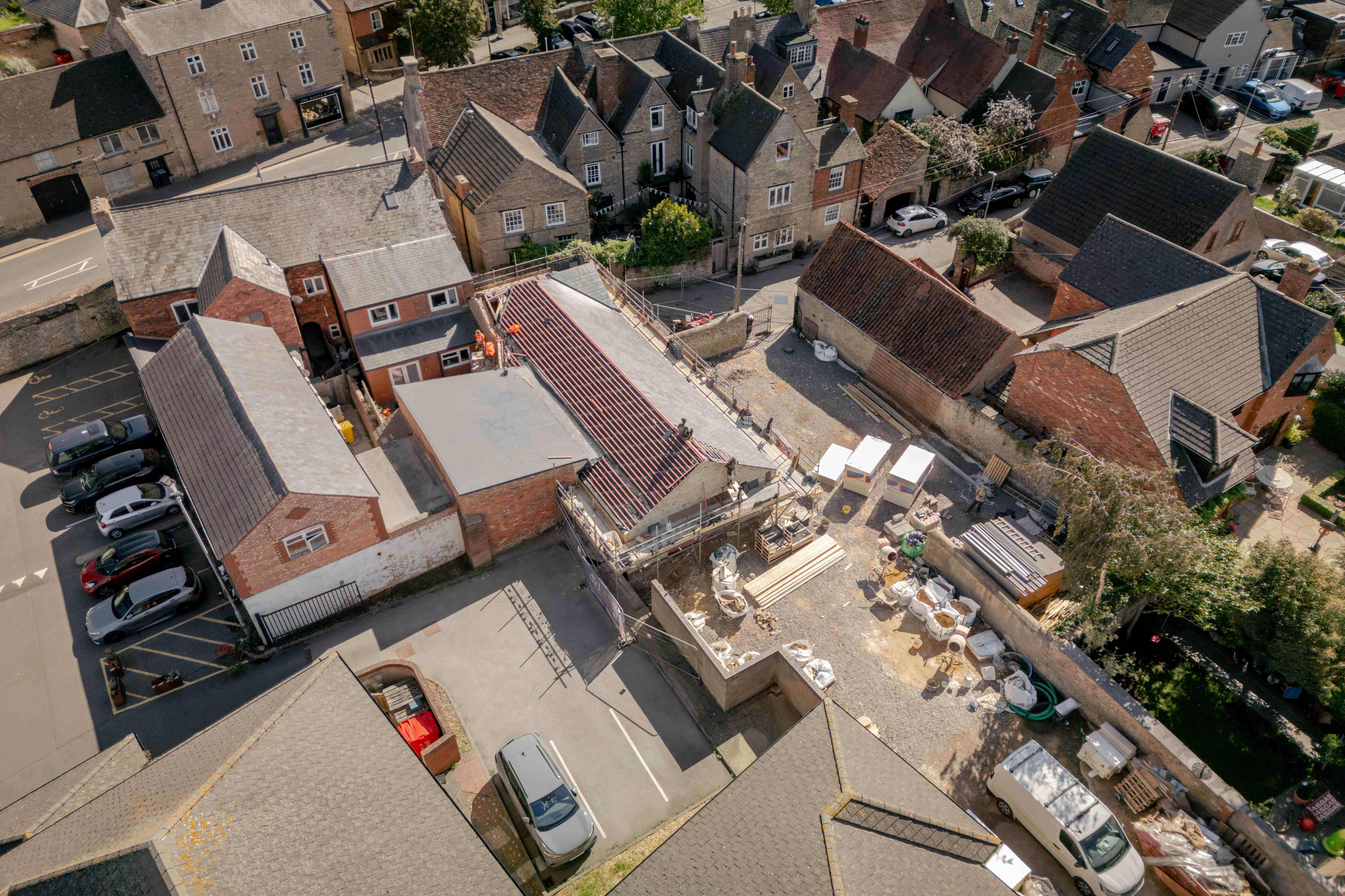The building rising within the square, from the air