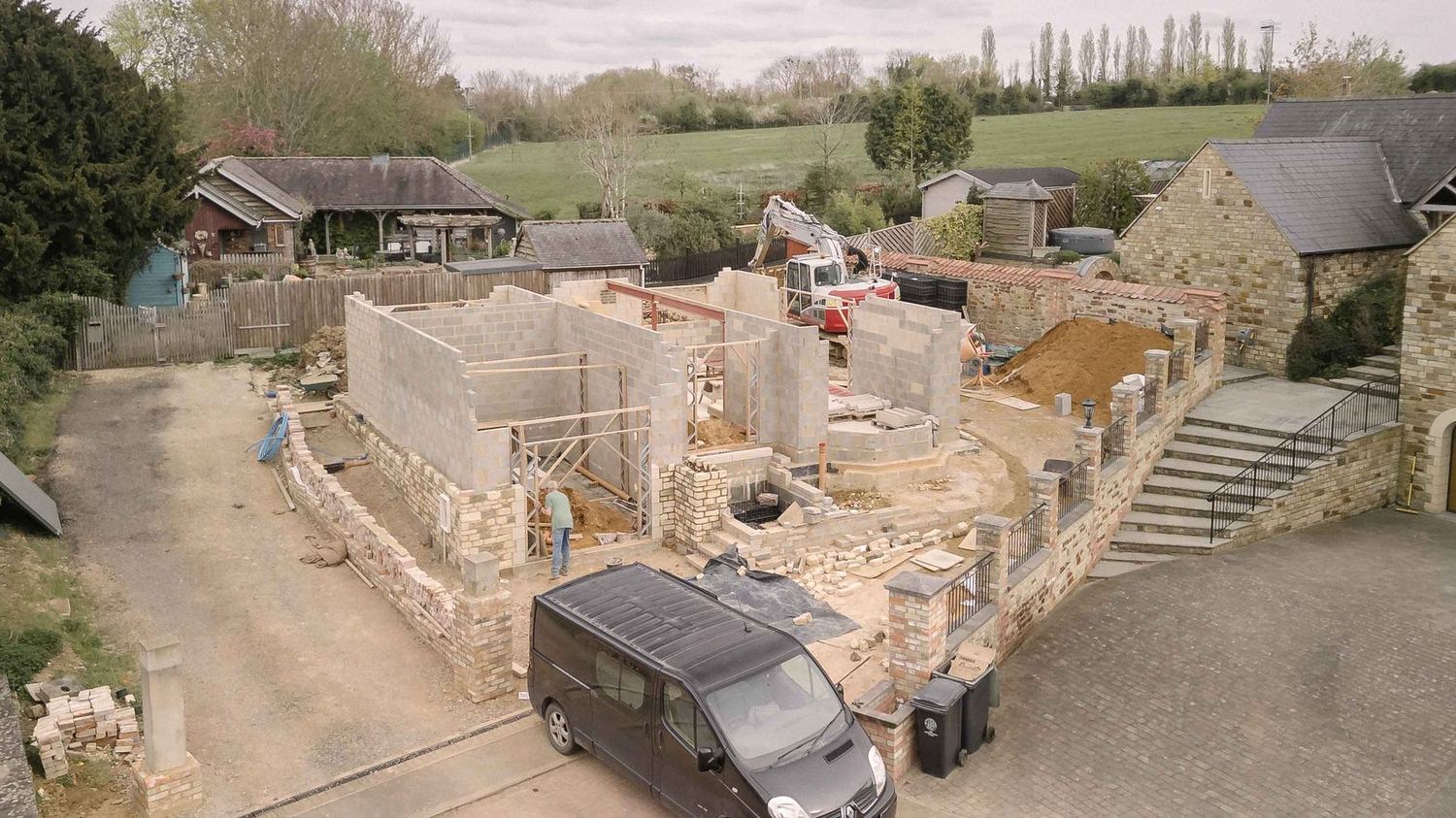 New stone house under construction, from the air