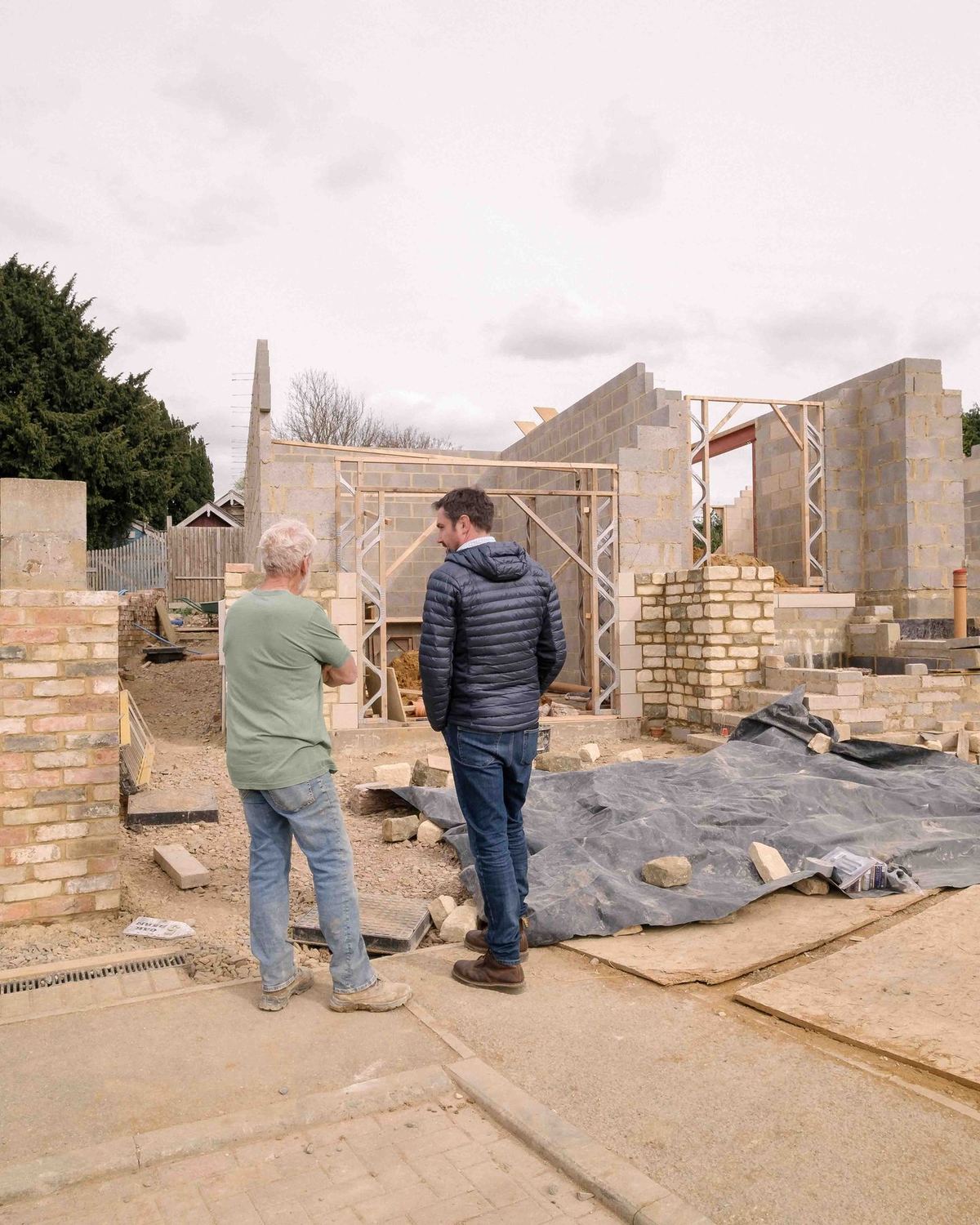 Bryn Lee on site with a client, reviewing the emerging structure at a Northamptonshire new-build