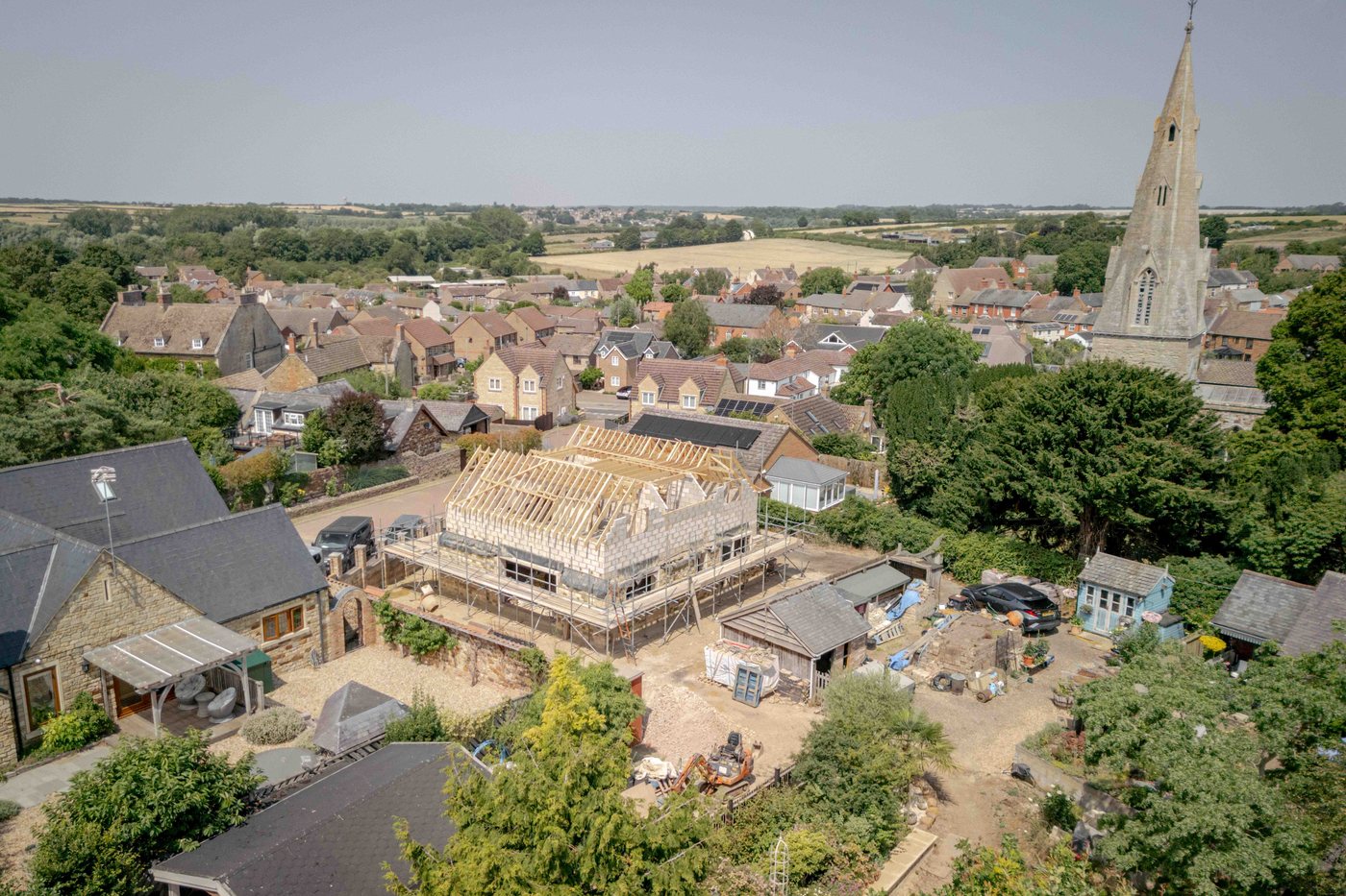 Middlefield from the air: the new stone house taking shape in the village, beside the church spire