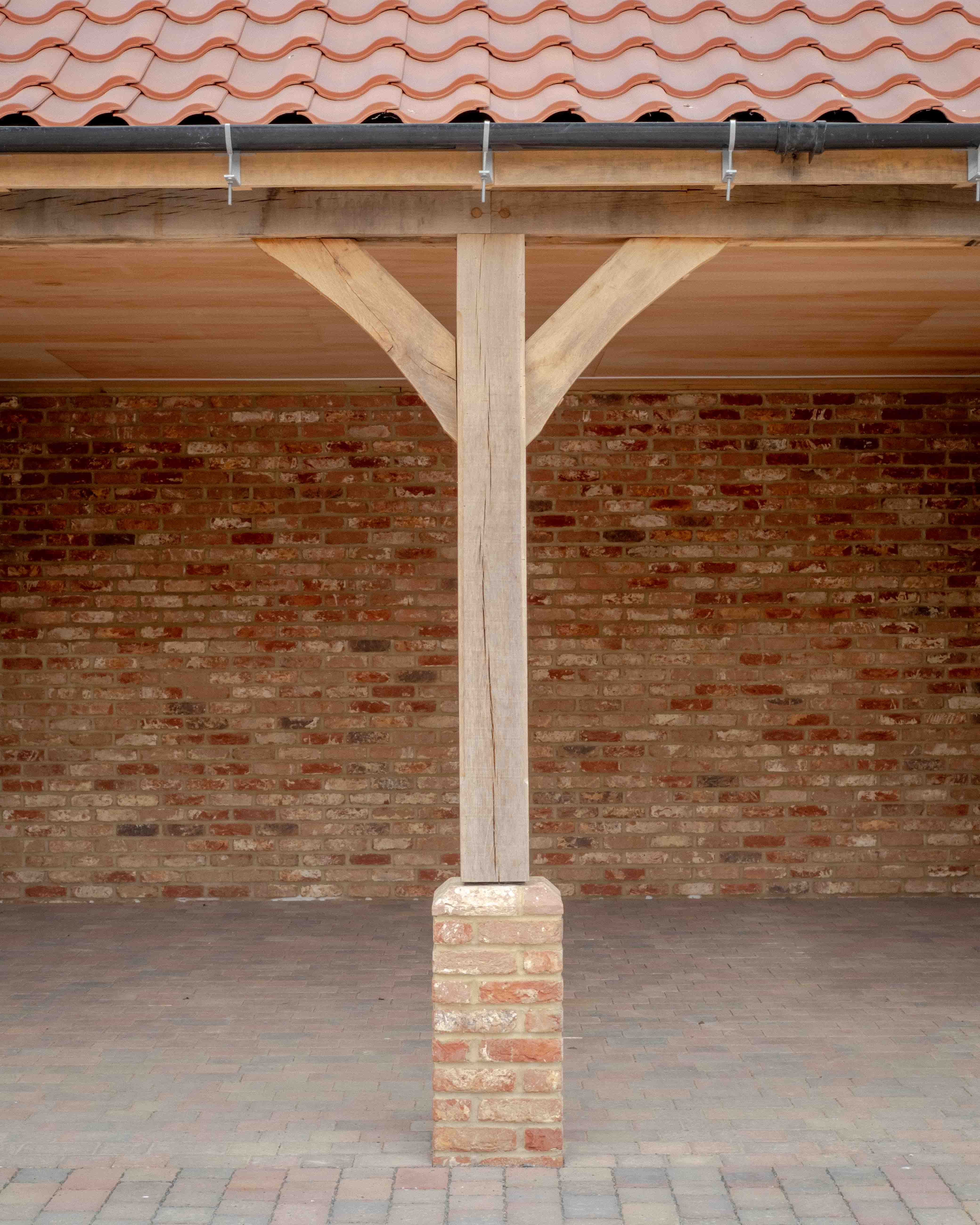 Inside the cart lodge: oak frame on brick piers