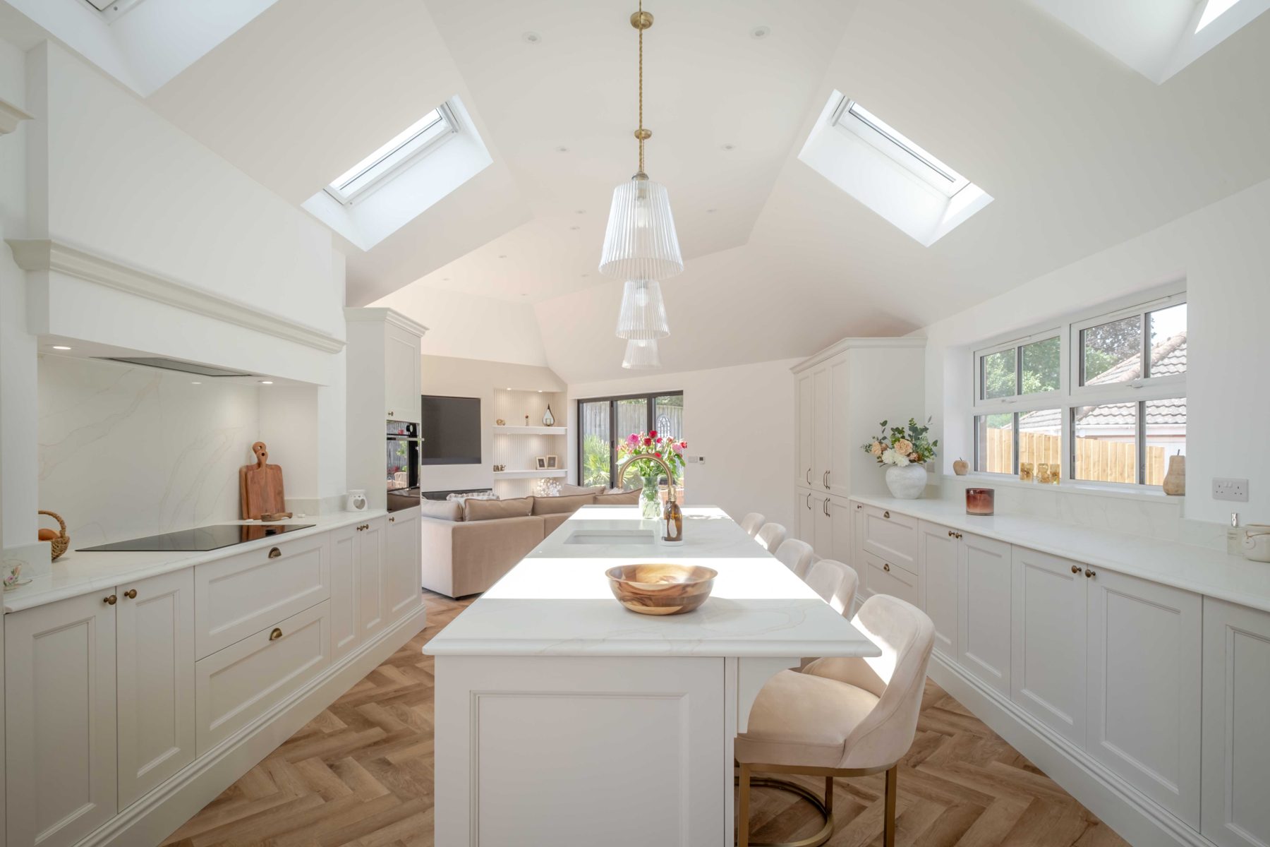 Looking down the long kitchen island at Teal Close, under a vaulted ceiling with rooflights